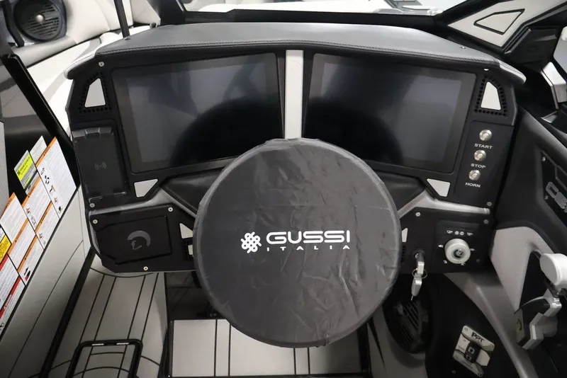 Slide: The Image of 2026 Centurion Ri245 boat dashboard with dual screens and Gussi Italia steering wheel cover. - 24