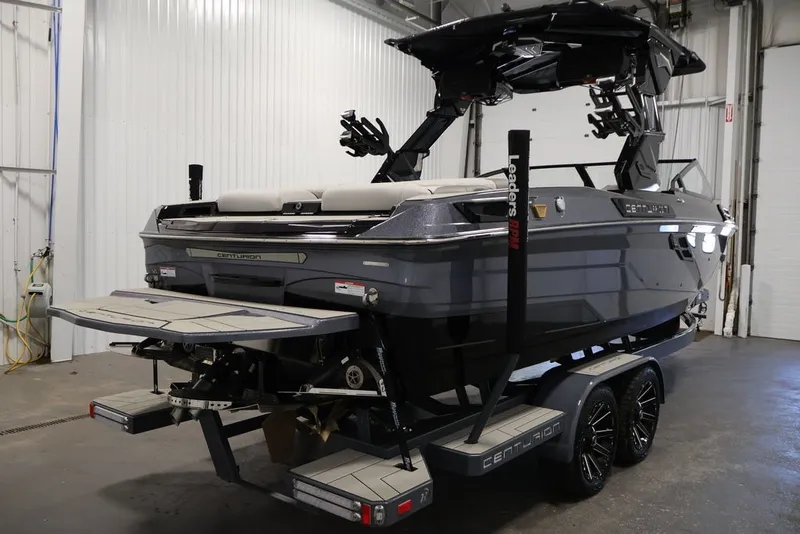 Slide: The Image of 2026 Centurion Ri245 boat in a garage, showcasing sleek design and modern features. - 2