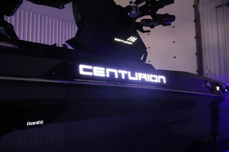 Slide: The Image of 2026 Centurion Ri245 boat with illuminated branding in a dimly lit setting. - 62