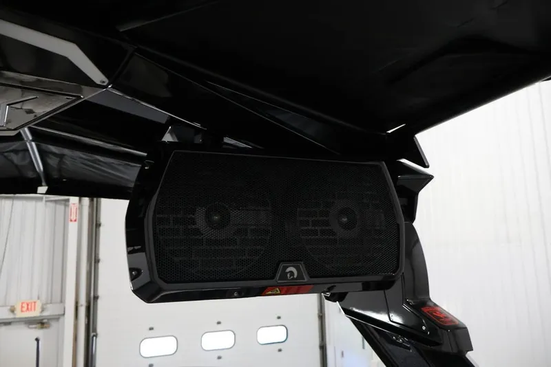 Slide: The Image of 2026 Centurion Ri245 boat speaker system under black canopy in a garage setting. - 44