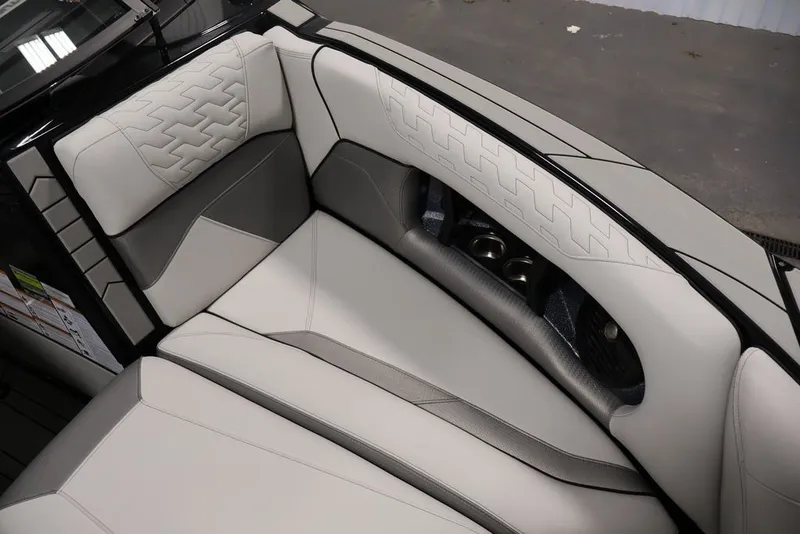 Slide: The Image of 2026 Centurion Ri245 boat interior with luxurious white and gray seating. - 23