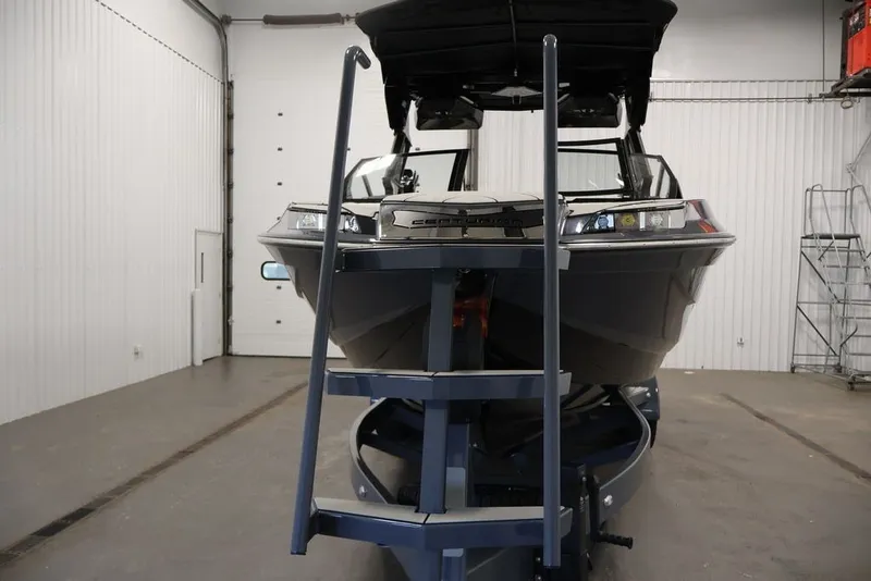 Slide: The Image of 2026 Centurion Ri245 boat in a garage, front view with trailer ladder. - 47
