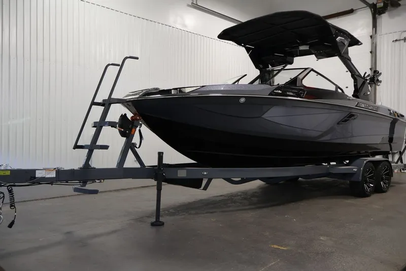 Slide: The Image of 2026 Centurion Ri245 boat on trailer in indoor storage facility. - 46