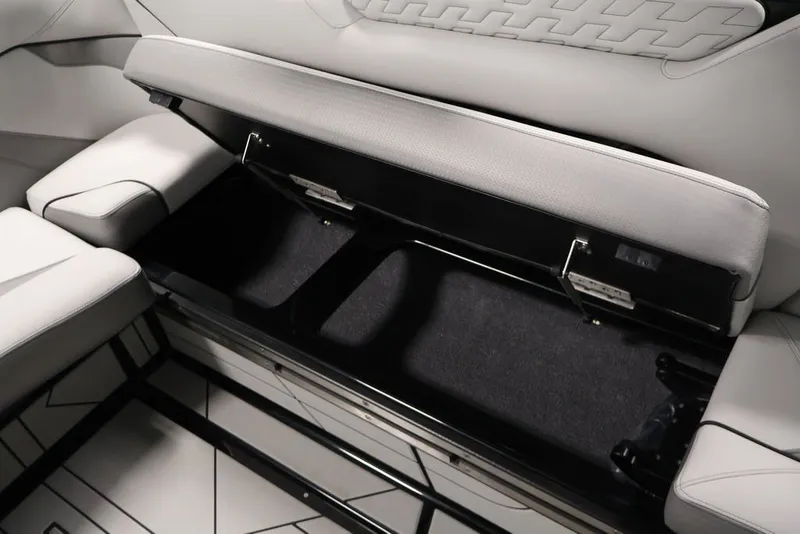 Slide: The Image of 2026 Centurion Ri245 boat interior storage compartment with open seat cushion. - 36