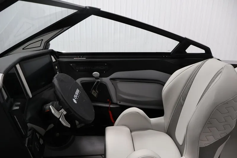 Slide: The Image of Interior of 2026 Centurion Ri245 boat with modern steering and luxurious seating. - 13