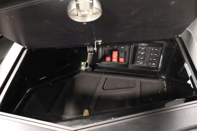 Slide: The Image of Storage compartment with control panel in 2026 Centurion Ri245 boat. - 28