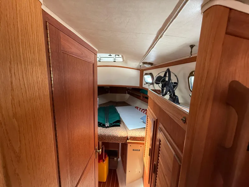 Slide: The Image of Interior of 1994 Pacific Seacraft 34 sailboat with wood finish and cozy seating. - 16