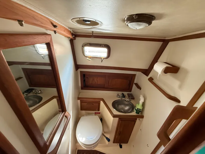 Slide: The Image of Interior cabin of a 1994 Pacific Seacraft 34 sailboat, featuring cozy sleeping quarters. - 18