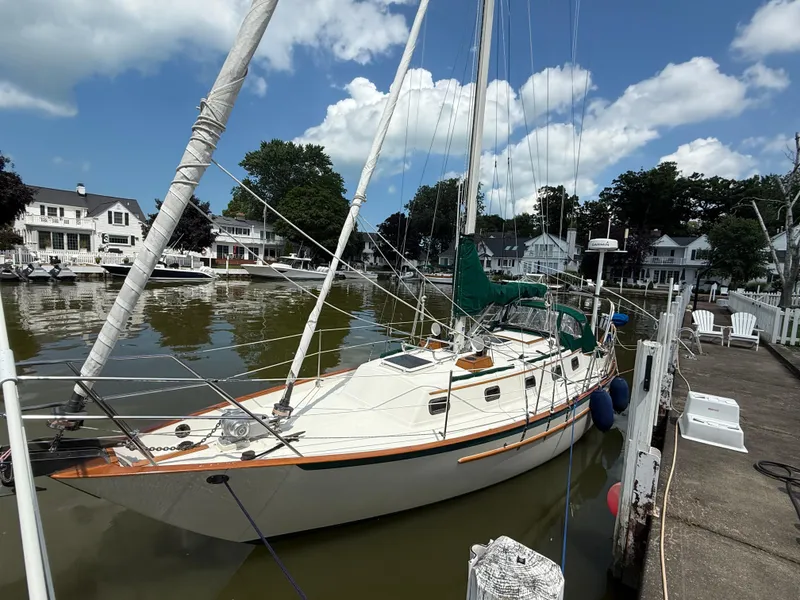 Slide: The Image of Sailboat docked in a marina, Pacific Seacraft 34, 1994 model, under a partly cloudy sky. - 2