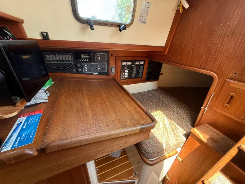 Slide: The Image of Interior of 1994 Pacific Seacraft 34 sailboat with wooden furnishings and cozy seating. - 20