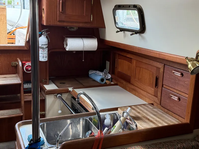 Slide: The Image of Interior of 1994 Pacific Seacraft 34 sailboat with wood finish and cozy seating area. - 22