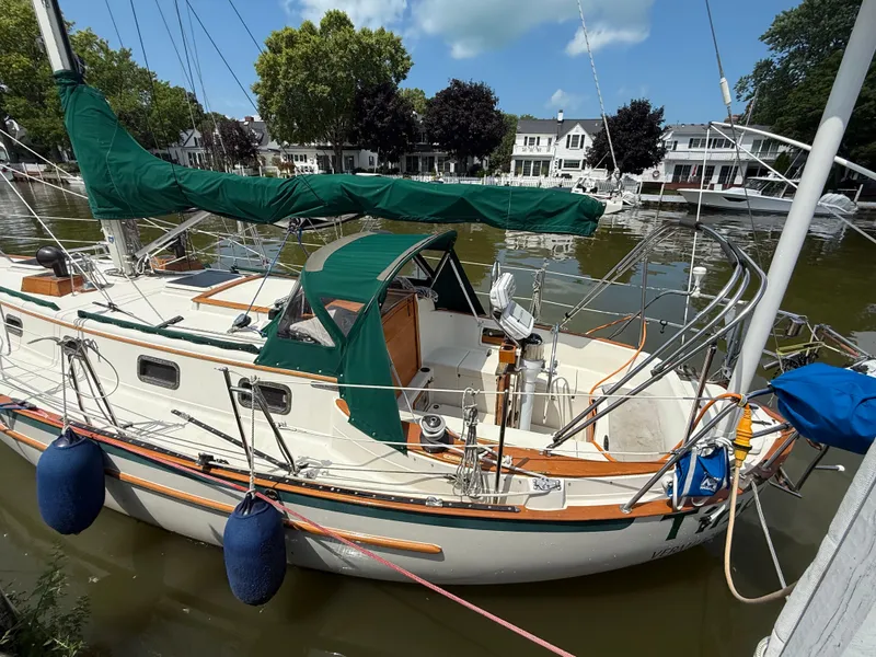 Slide: The Image of 1994 Pacific Seacraft 34 sailboat docked by charming waterfront homes. - 4