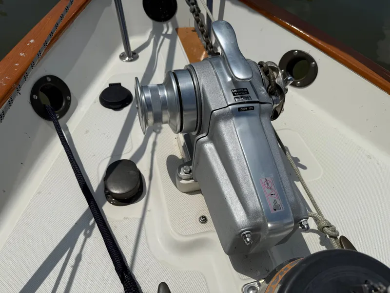 Slide: The Image of 1994 Pacific Seacraft 34 sailboat docked near waterfront homes under a clear blue sky. - 7