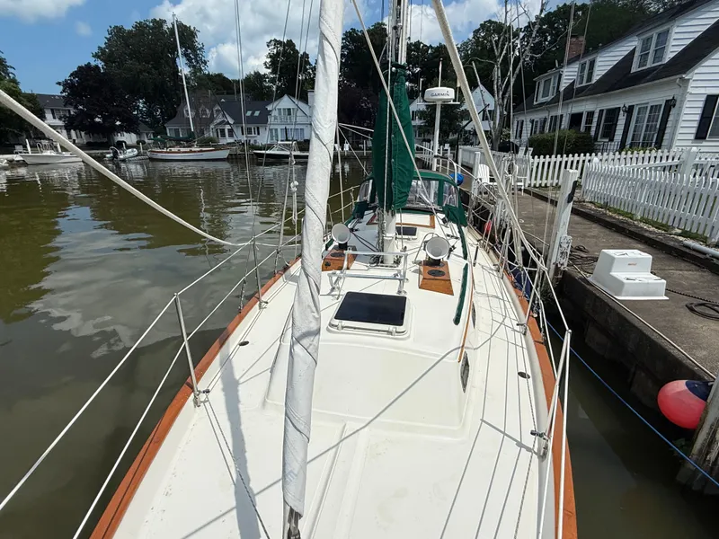 Slide: The Image of Anchor windlass on 1994 Pacific Seacraft 34 sailboat deck, featuring polished metal and rope details. - 8