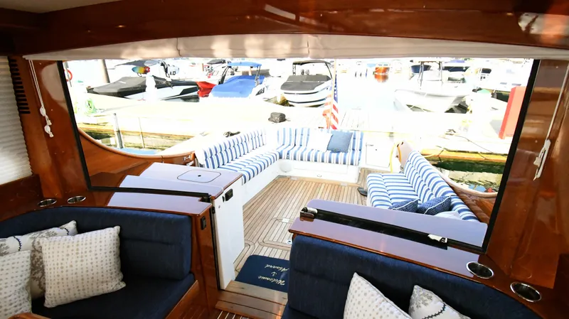 Slide: The Image of Interior view of 2022 Hinckley Talaria 43 yacht with striped seating and wooden finishes. - 11