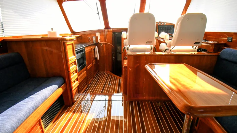 Slide: The Image of Luxurious interior of 2022 Hinckley Talaria 43 yacht with wood finish and seating. - 7