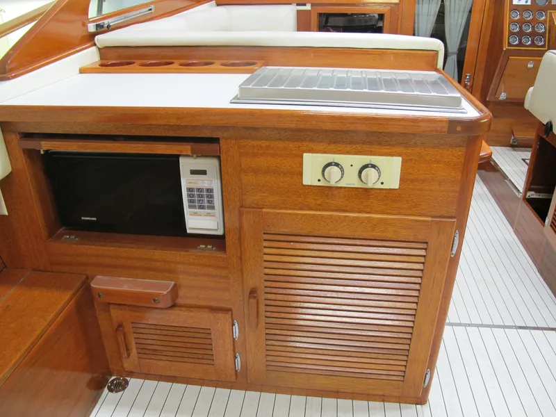 Slide: The Image of Wooden interior of 1991 Windsor Craft 310 boat with microwave and control panel. - 12