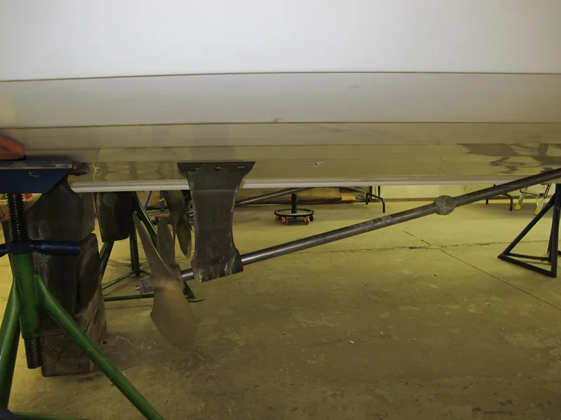 Slide: The Image of 1991 Windsor Craft 310 boat propeller and shaft in a workshop setting. - 18