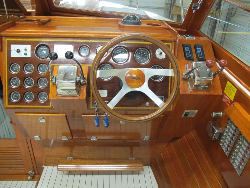 Slide: The Image of 1991 Windsor Craft 310 boat dashboard with wooden finish and classic steering wheel. - 6