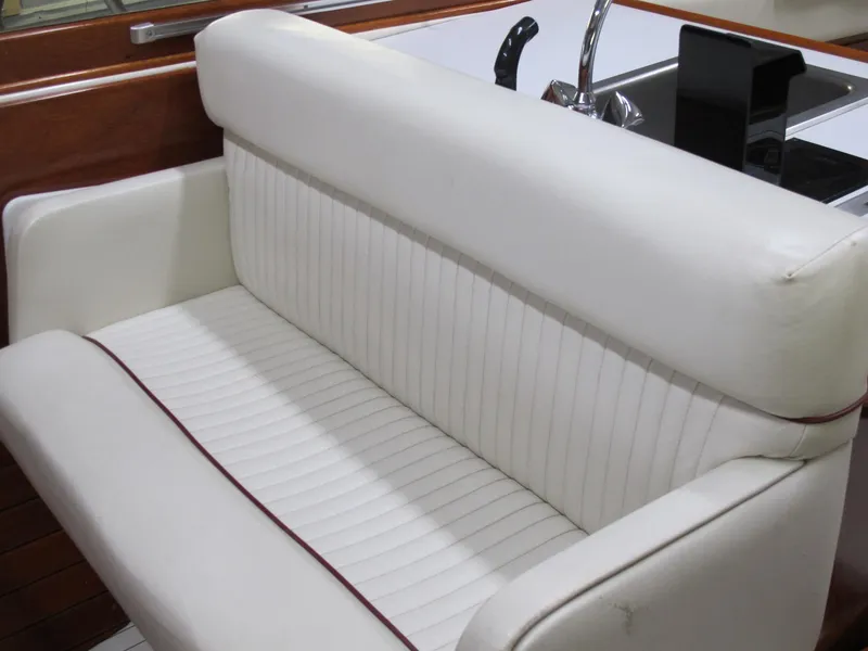 Slide: The Image of White leather seating on a 1991 Windsor Craft 310 boat interior. - 9