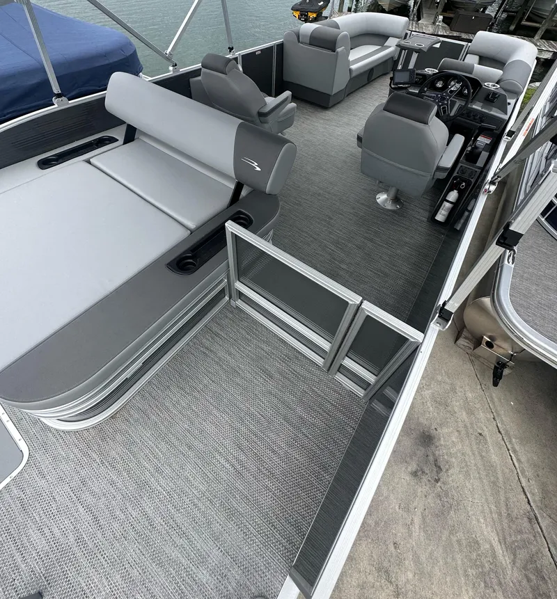 Slide: The Image of 2024 Bennington SV 22 Swingback pontoon boat interior with gray seating and helm. - 6