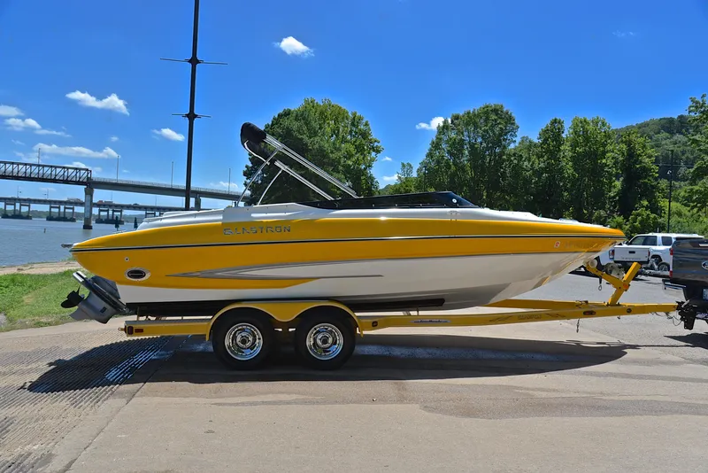 Slide: The Image of 2007 Glastron GXL 235 boat on trailer by river, sunny day, blue sky. - 14