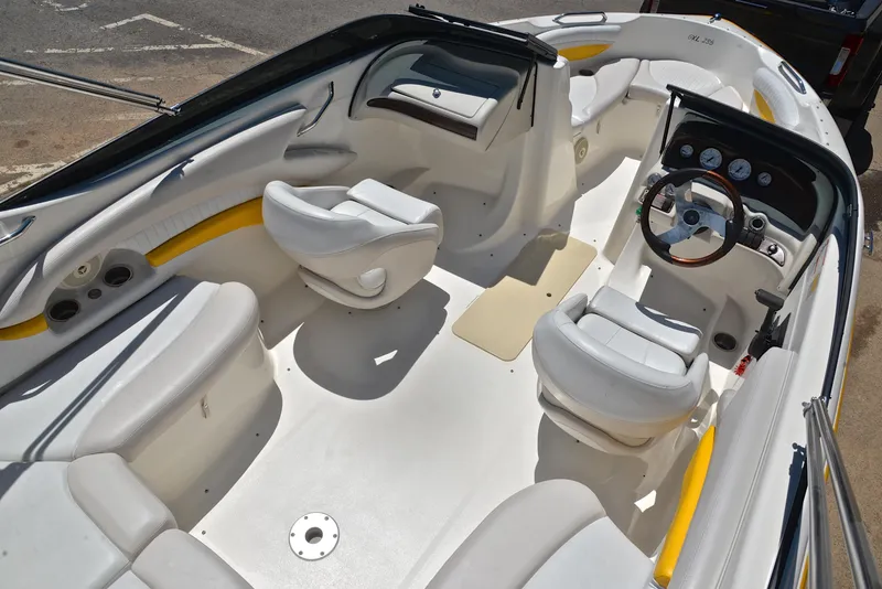 Slide: The Image of 2007 Glastron GXL 235 boat interior with white seating and steering console. - 18