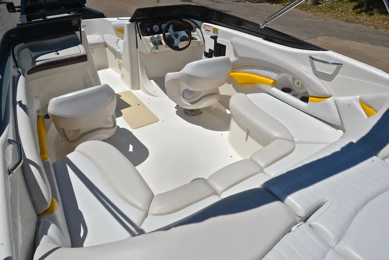 Slide: The Image of 2007 Glastron GXL 235 boat interior with white and yellow seating, steering wheel, and dashboard. - 22