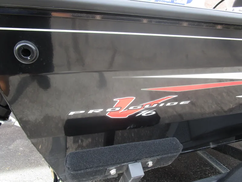 Slide: The Image of 2024 Tracker Pro Guide V16 WT boat, black exterior with red and white graphics. - 10