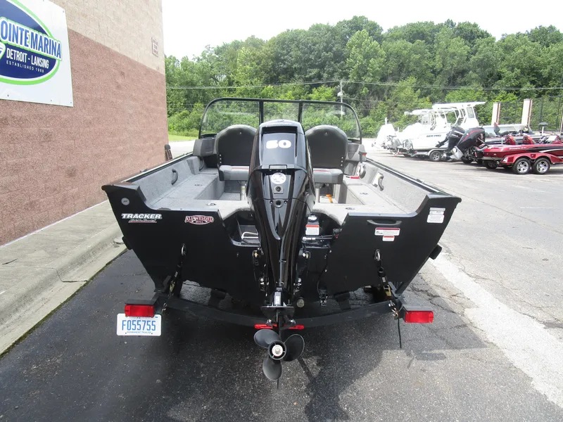 Slide: The Image of 2024 Tracker Pro Guide V16 WT boat, rear view, parked at marina. - 11