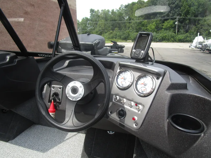 Slide: The Image of 2024 Tracker Pro Guide V16 WT boat dashboard with steering wheel and gauges. - 8