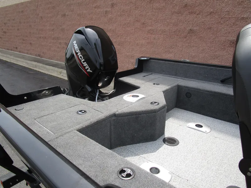 Slide: The Image of 2024 Tracker Pro Guide V16 WT boat interior with Mercury engine, showcasing seating and storage. - 9
