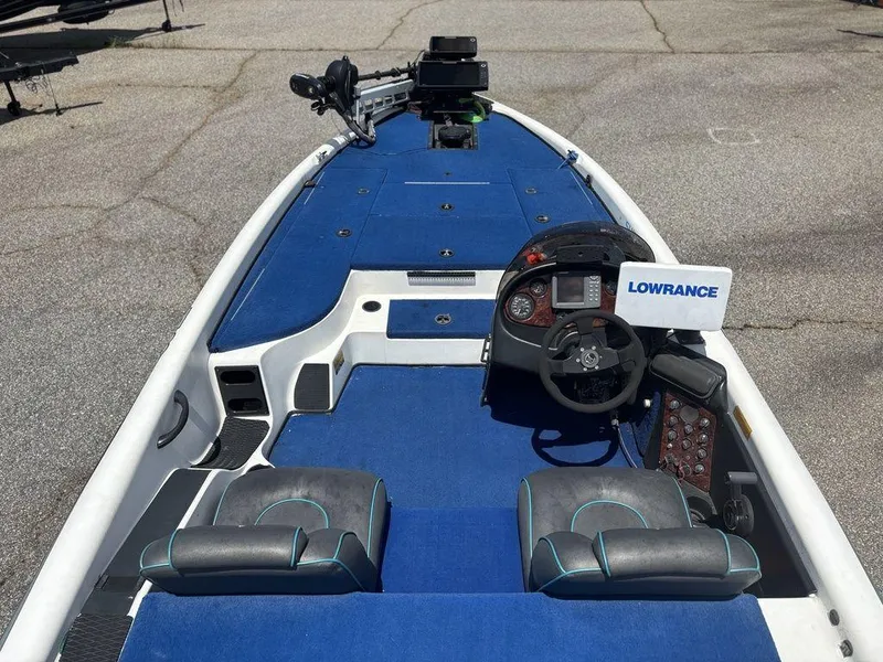 Slide: The Image of 2000 Triton TR20 boat interior with blue carpet and Lowrance electronics. - 19
