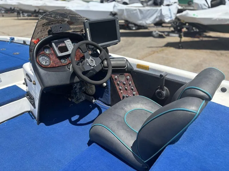 Slide: The Image of Interior of a 2000 Triton TR20 boat with steering wheel and control panel. - 20