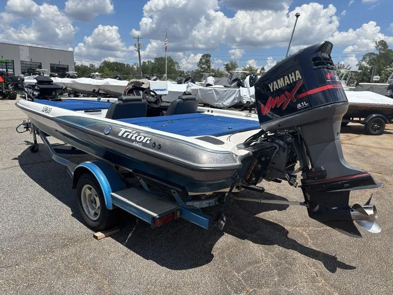 Slide: The Image of 2000 Triton TR20 boat with Yamaha VMAX engine, parked outdoors under a cloudy sky. - 5