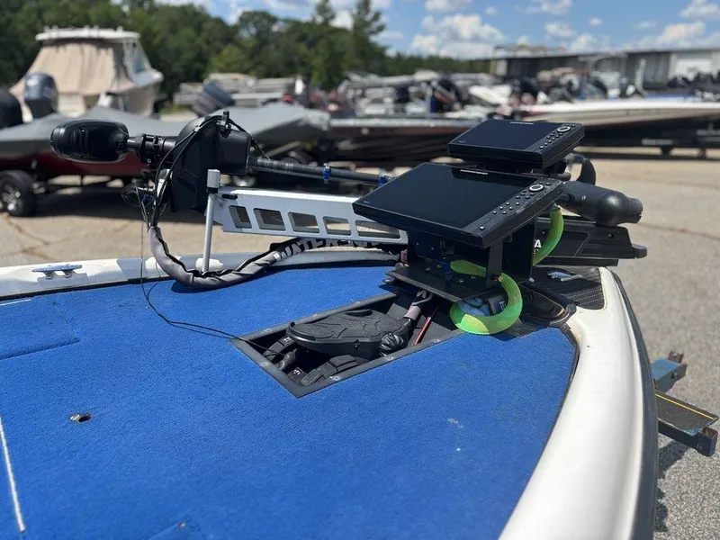 Slide: The Image of Triton TR20 boat dashboard with electronic equipment, 2000 model, parked outdoors. - 7