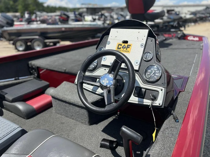 Slide: The Image of 2017 Ranger RT188 boat dashboard with steering wheel and gauges in a marina setting. - 12