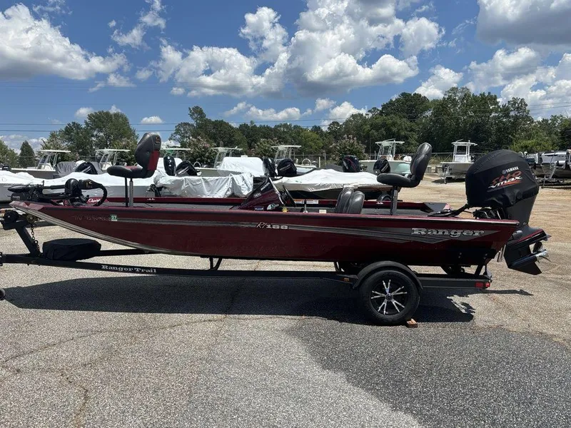 Slide: The Image of 2017 Ranger RT188 boat on trailer under a blue sky with clouds. - 5