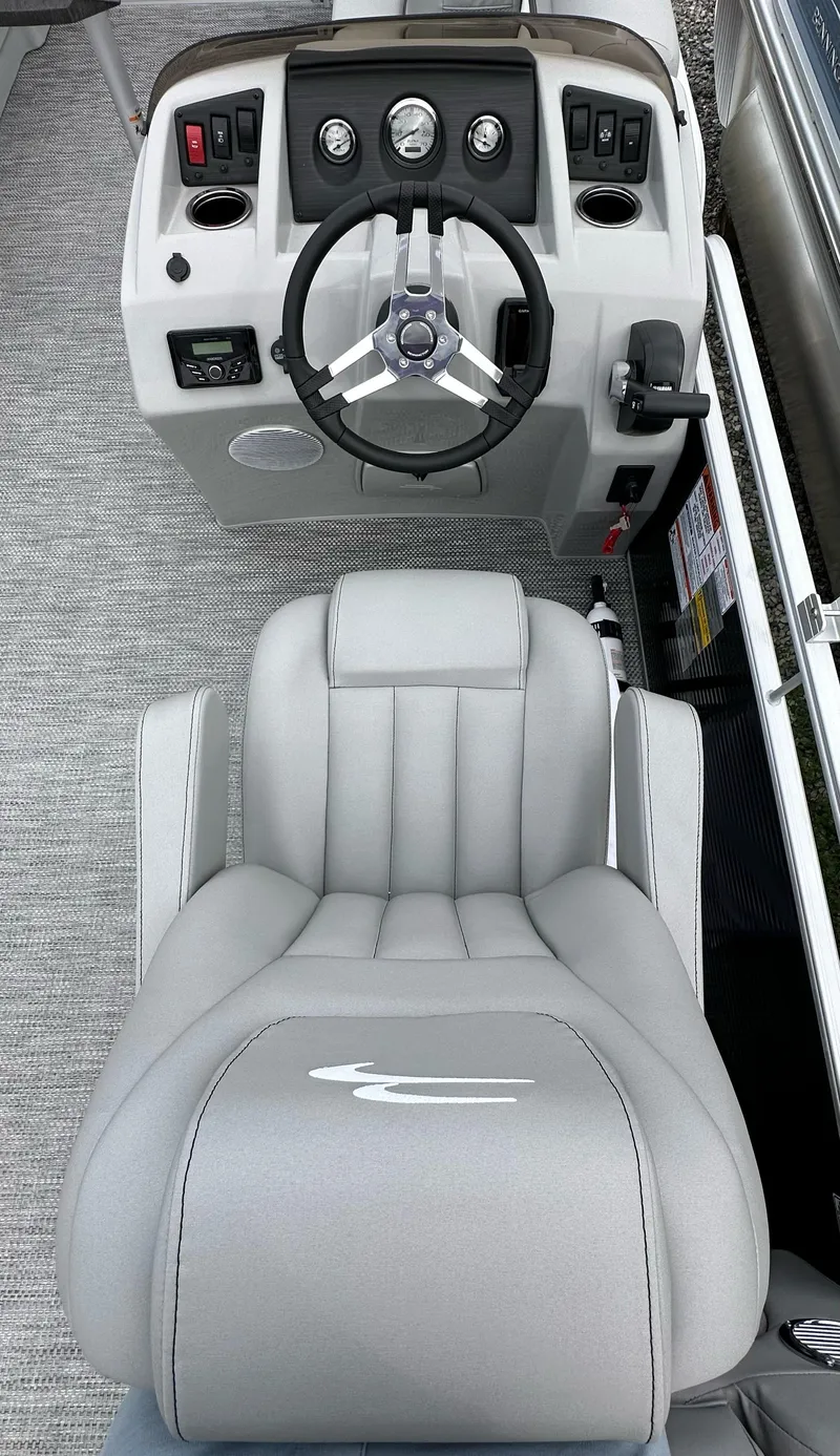 Slide: The Image of 2024 Bennington SV 22 Quad Bench boat interior with steering wheel and captain's chair. - 3