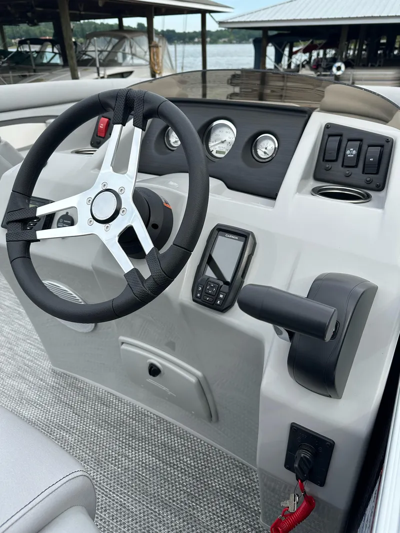 Slide: The Image of 2024 Bennington SV 22 Quad Bench dashboard with steering wheel and controls. - 7