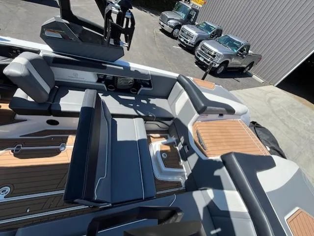 Slide: The Image of 2019 Correct Craft Nautique G 25 Super Air boat interior with luxury seating and wood accents. - 13