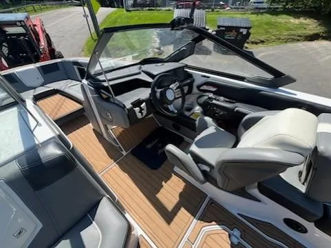 Slide: The Image of 2019 Correct Craft Nautique G 25 Super Air boat interior with sleek design and modern controls. - 15