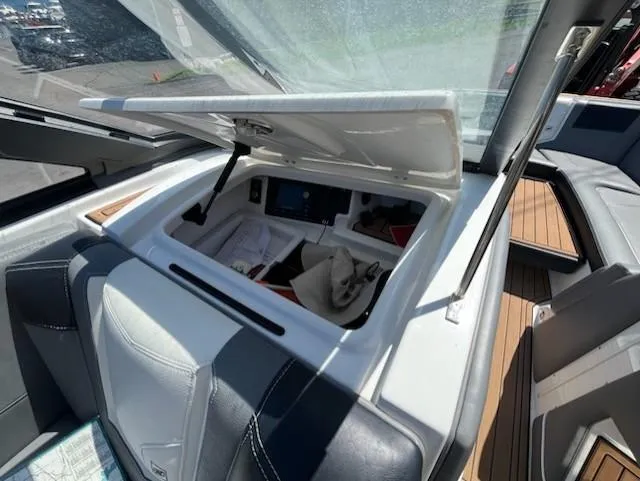 Slide: The Image of 2019 Correct Craft Nautique G 25 Super Air boat interior storage compartment open. - 17