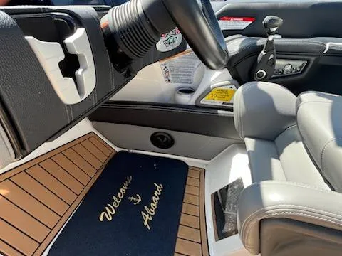 Slide: The Image of 2019 Correct Craft Nautique G 25 Super Air interior with "Welcome Aboard" mat and sleek seating. - 21