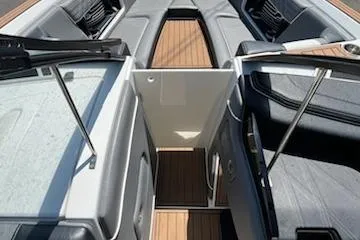 Slide: The Image of 2019 Correct Craft Nautique G 25 Super Air boat interior with sleek seating and wood flooring. - 24