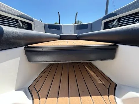 Slide: The Image of 2019 Correct Craft Nautique G 25 Super Air boat interior with sleek seating and wooden flooring. - 25