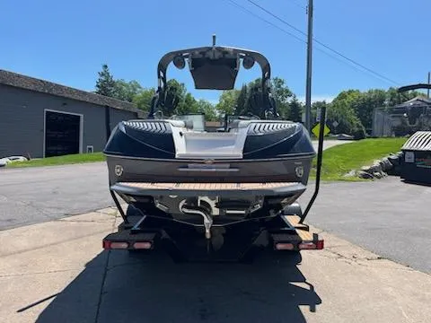 Slide: The Image of 2019 Correct Craft Nautique G 25 Super Air boat, rear view, parked outdoors. - 3