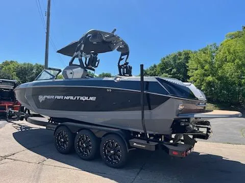 Slide: The Image of 2019 Correct Craft Nautique G 25 Super Air boat on trailer, parked outdoors. - 4