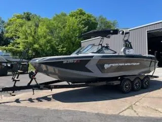 Slide: The Image of 2019 Correct Craft Nautique G 25 Super Air boat on trailer, parked outdoors. - 5