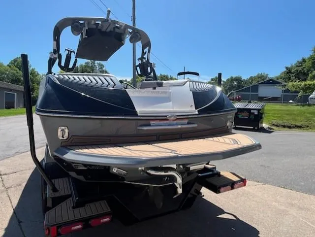 Slide: The Image of 2019 Correct Craft Nautique G 25 Super Air boat, rear view, parked outdoors. - 6